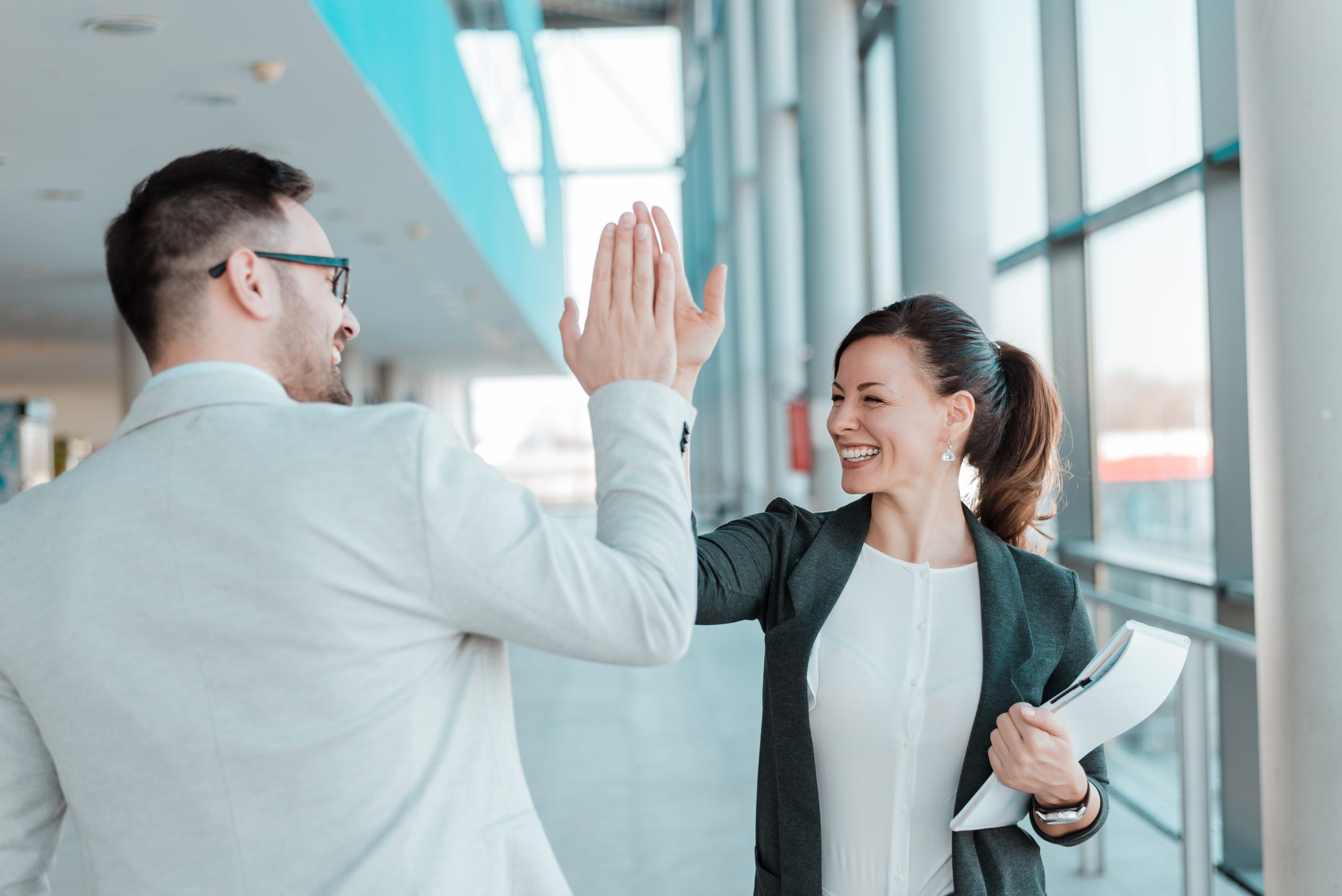 High-Five_Two-business-people-high-five_AdobeStock_188725620-scaled