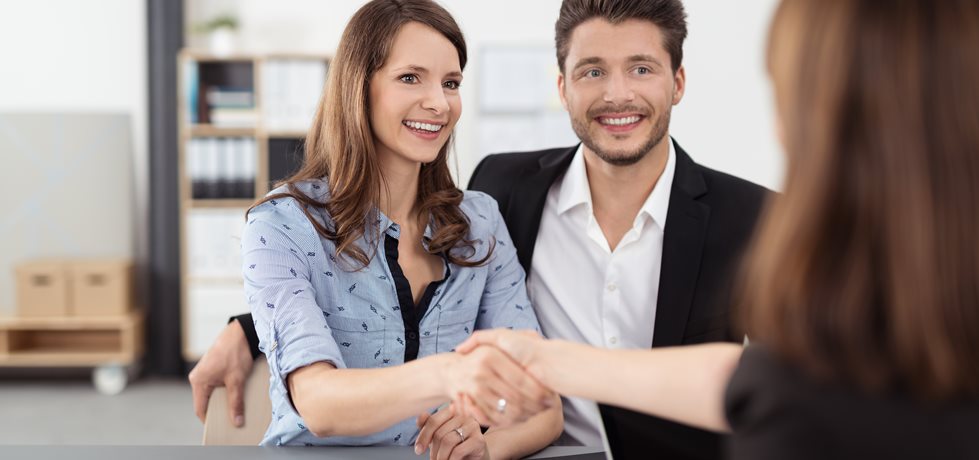 Happy,Young,Professional,Couple,Shaking,Hands,With,A,Real,Estate